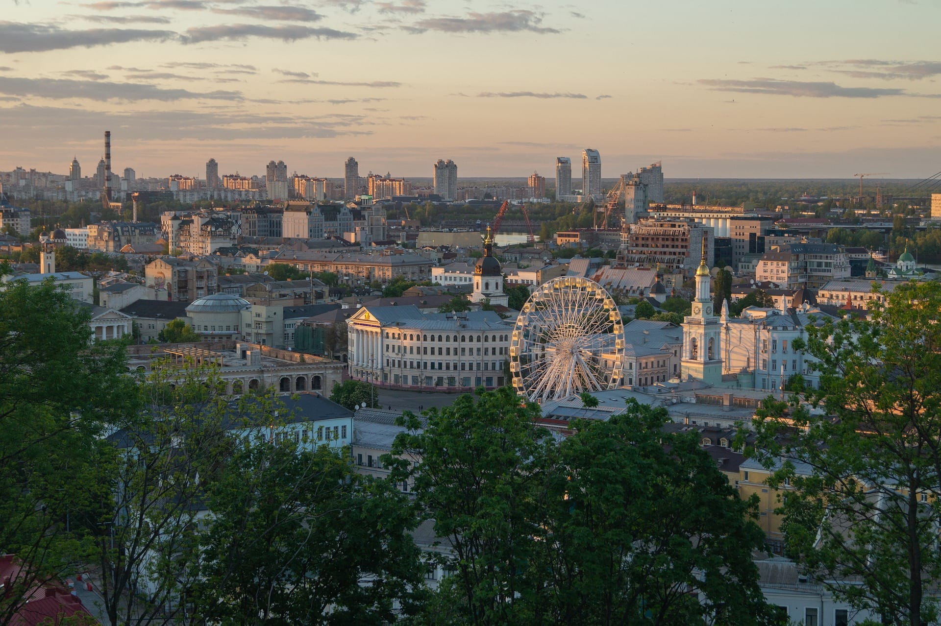 Kyiv Podil skyline at sunset with ferris wheel